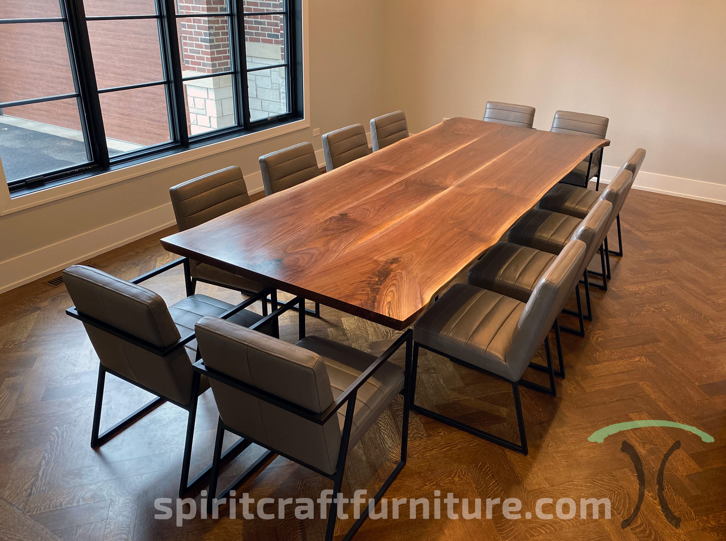 https://www.greatspirithardwoods.com/img/slab-live-edge-tops/large-black-walnut-live-edge-dining-table-for-chicago-il-area-client-with-modern-leather-and-steel-chairs.jpg